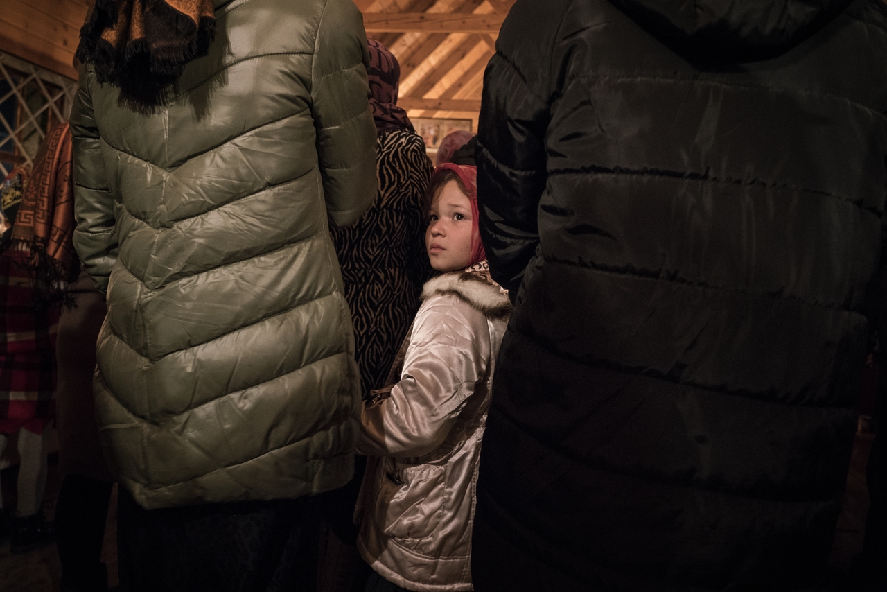 a child during a mass on the orthodox Christmas in Ochamchire
